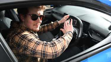 Auto Express content editor Ryan Birch pressing the MG3's horn button